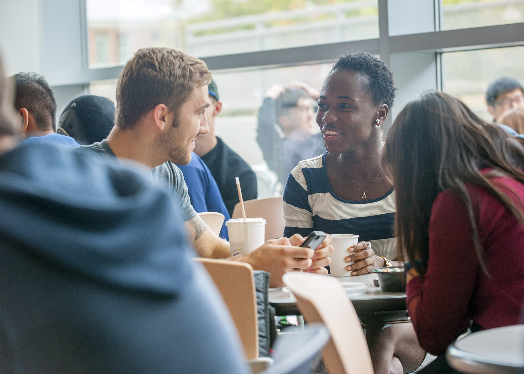 Small group of students talk during lunch in the Student Union